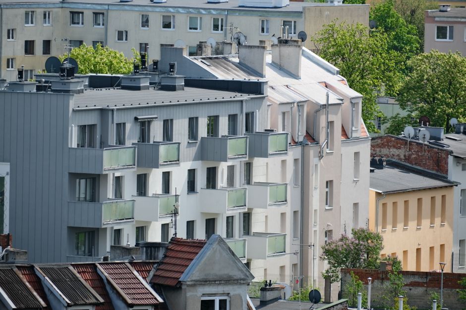 Contemporary apartment buildings in a vibrant city neighborhood with lush greenery